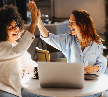 women high fiving
